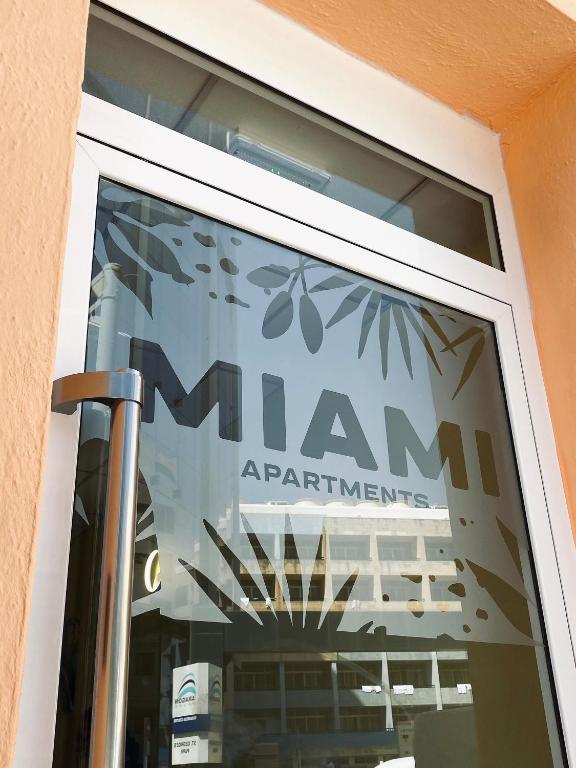 a window of a building with a sign that reads ram apartments at Miami Apartments in St. Julianʼs