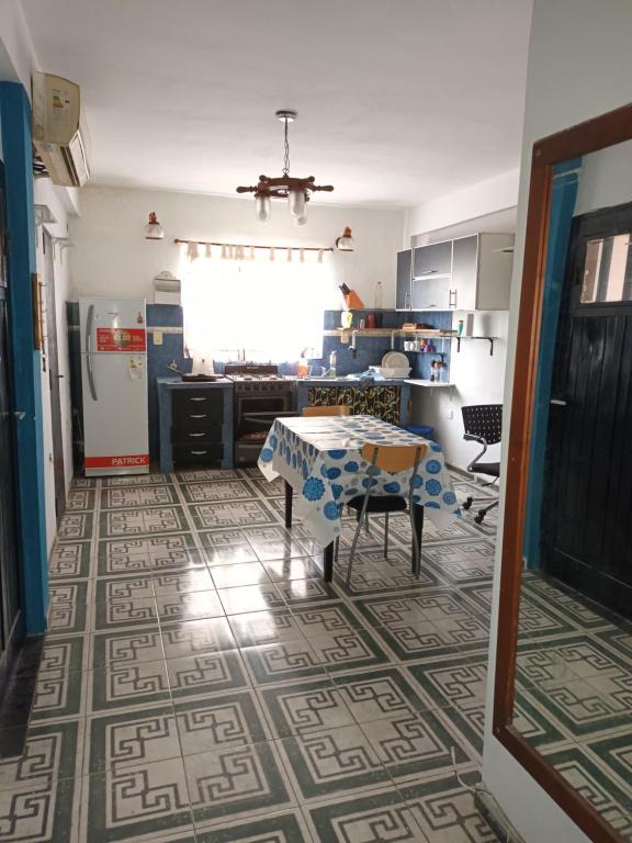 a kitchen with a table in the middle of a room at Lasemes in Laferrere