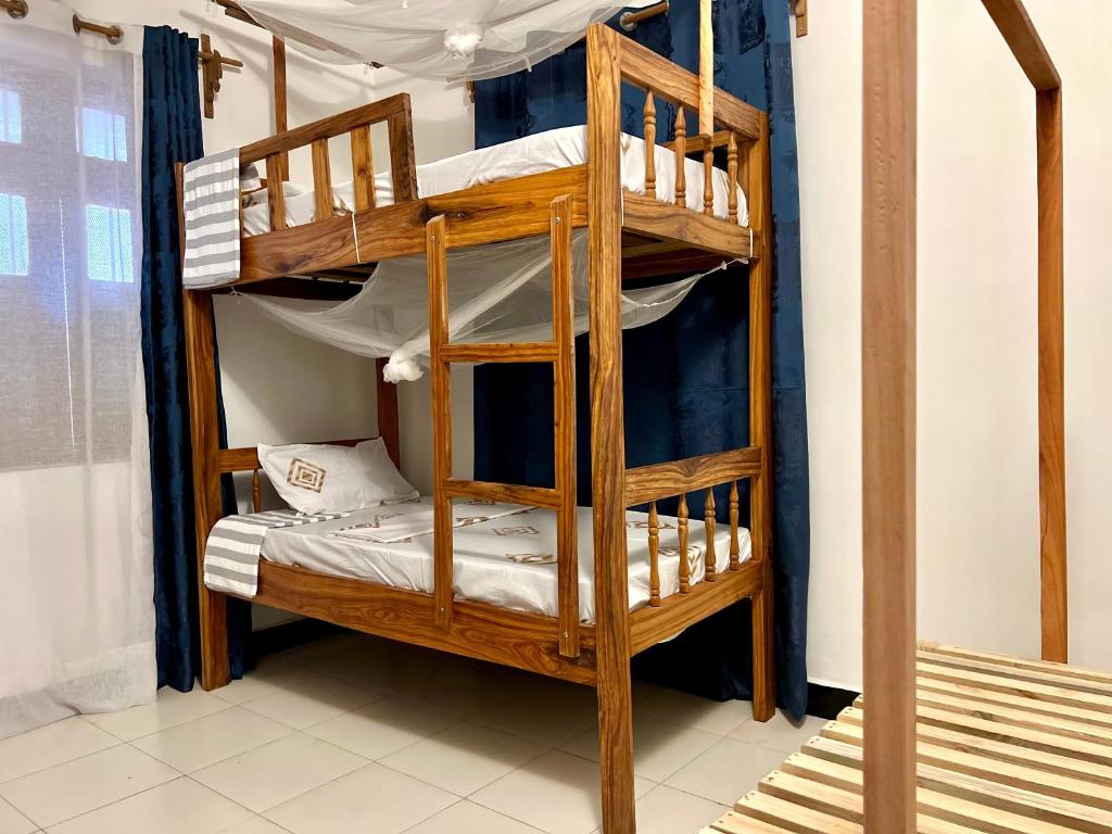 a bunk bed in a room with a bunk bed in a room at Serene Abodes in Stone Town