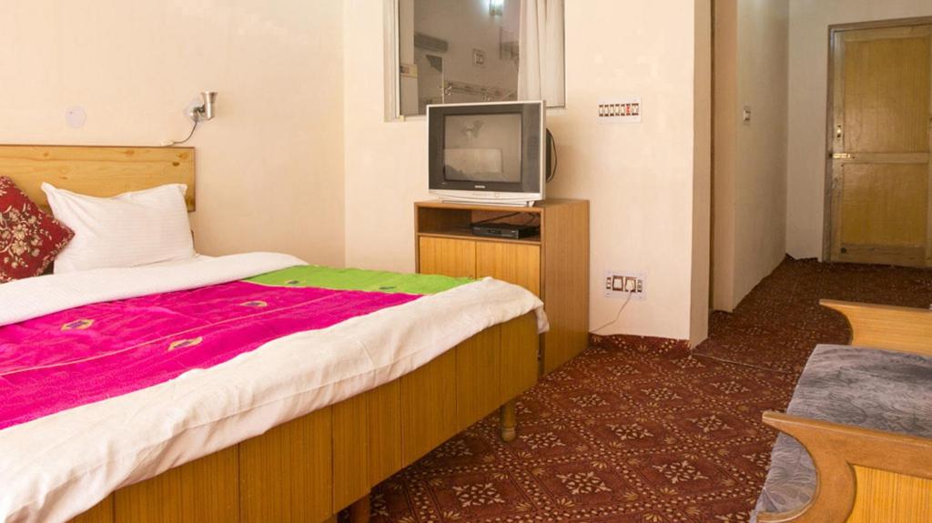 Rúm í herbergi á Siala Guest House