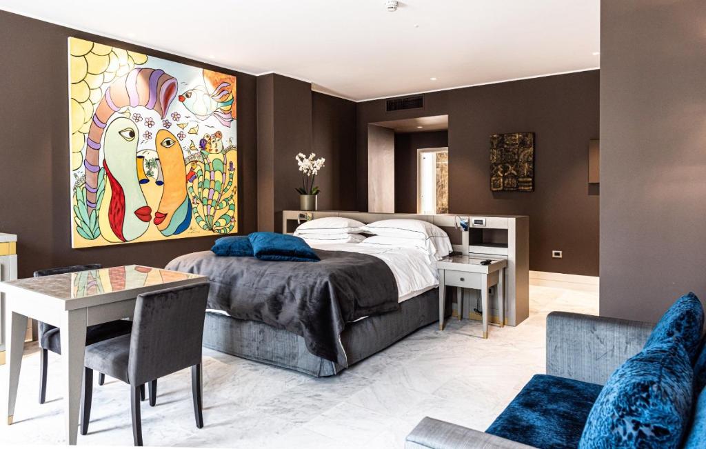 a bedroom with a large bed and a living room at Palazzo Doglio in Cagliari