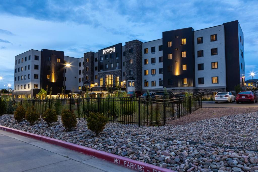 a row of buildings in a city at night at Staybridge Suites - Colorado Springs NE Powers, an IHG Hotel in Colorado Springs