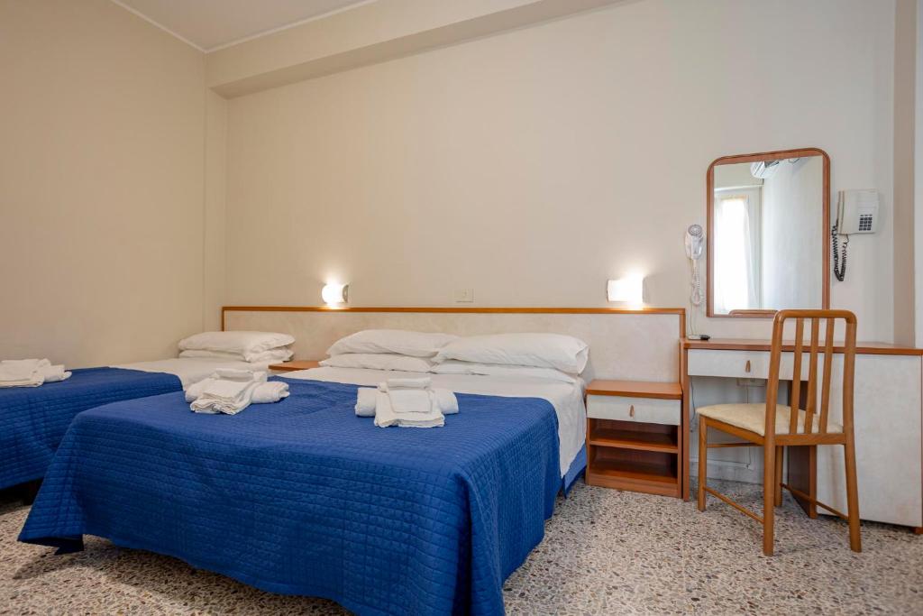 Postel nebo postele na pokoji v ubytování Hotel Stella Del Mare