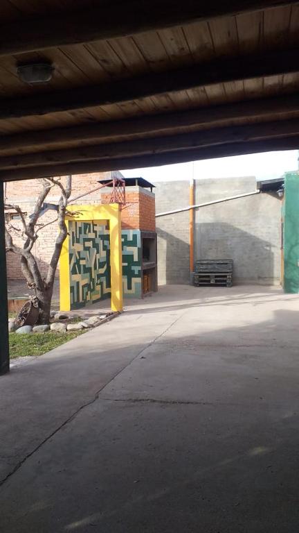 an empty parking lot with a bench under a bridge at Lo de Tere P/8! in Malargüe