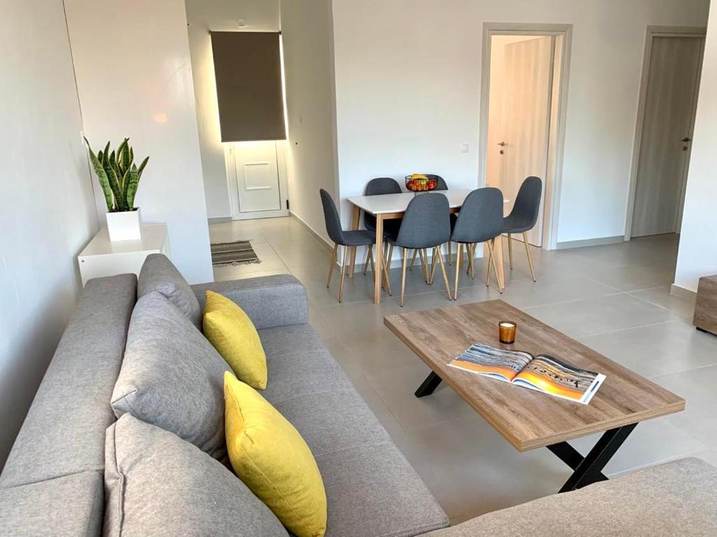a living room with a couch and a table at Lýria Boutique Apartments in Lygia