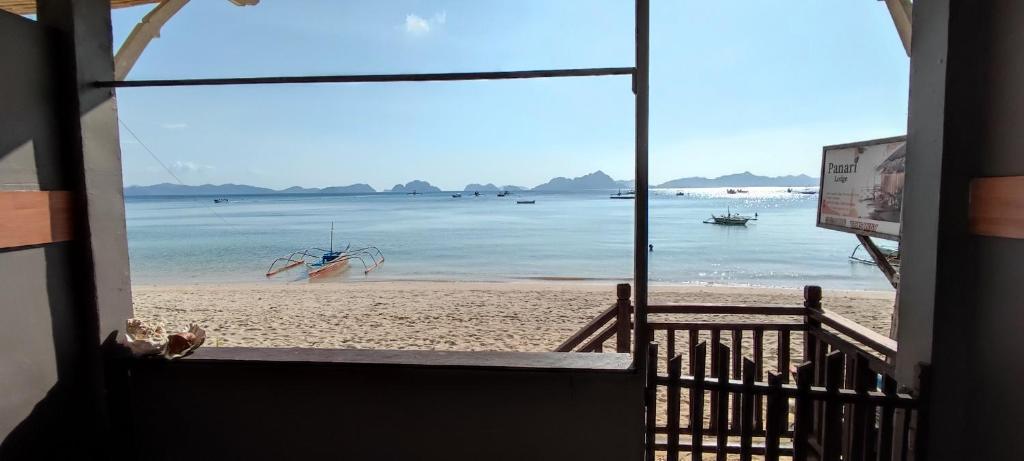 a view of a beach from a window of a building at ALFA Beach Front Lodge in El Nido