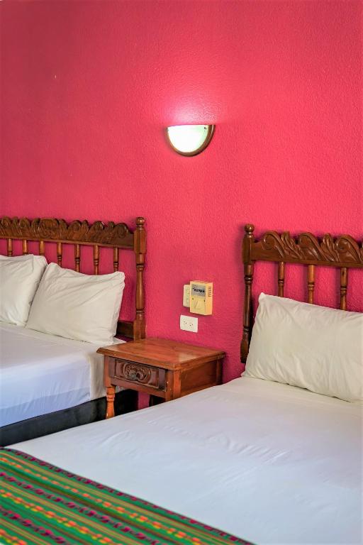 Postel nebo postele na pokoji v ubytování Hotel San Juan Mérida
