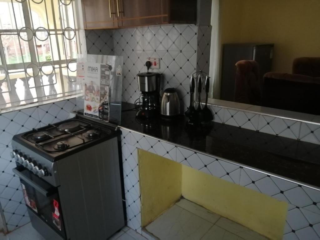 a kitchen with a stove and a counter top at Mwamba Homes in Kisii
