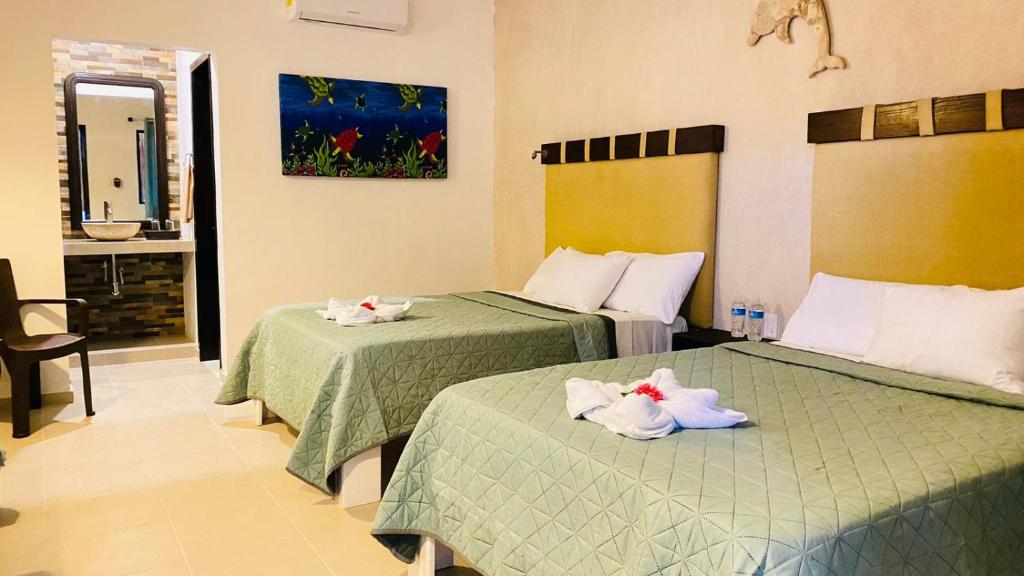 Postel nebo postele na pokoji v ubytování CASA DELFINES RIO LAGARTOS