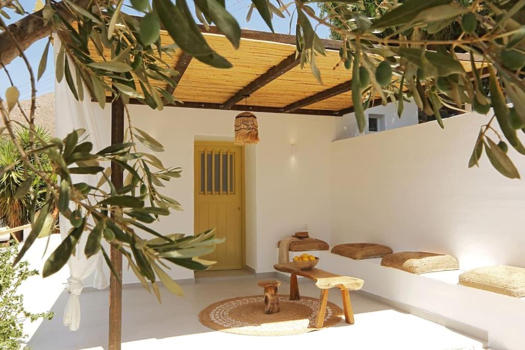 a room with two beds and a table and trees at Syrolia village in Kinion