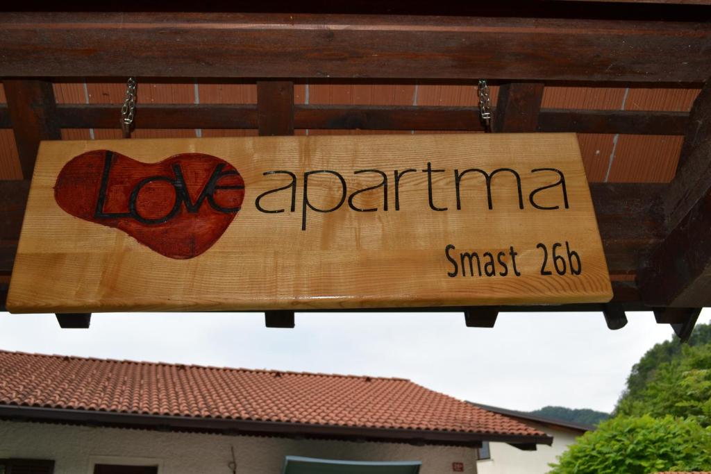 a sign that says love aprilimus suggest at Apartment Love Smast in Kobarid