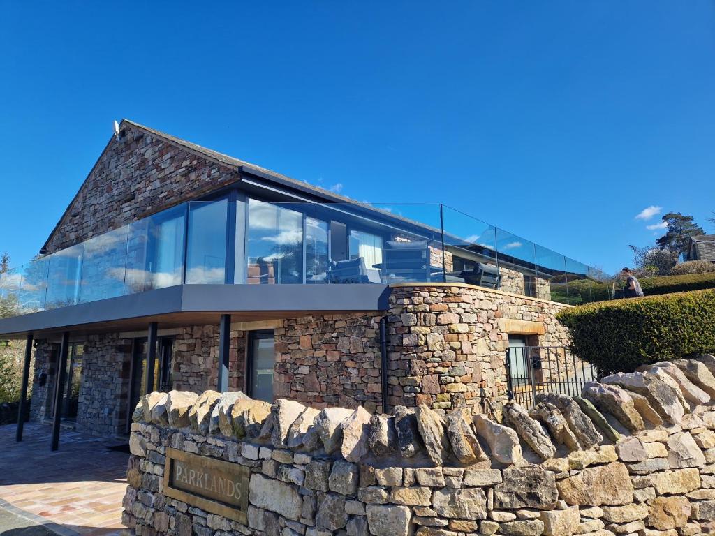 a stone building with a stone wall at Parklands in Penrith
