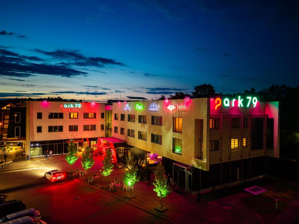a building with christmas lights on it at night at Grape Town Hotel - Park79 in Zielona Góra