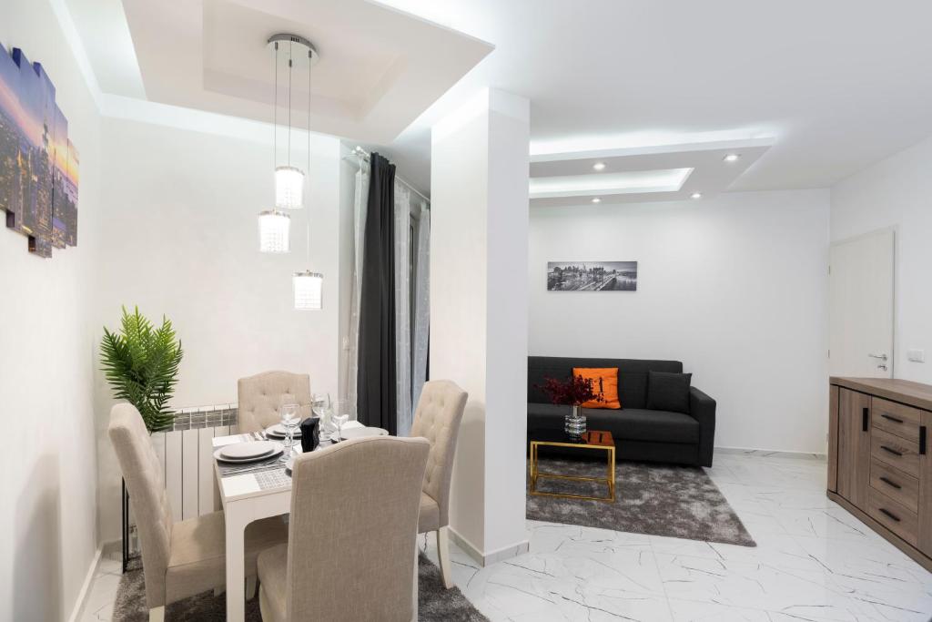 a living room with a table and a couch at Top Central Apartment & Free Parking in Sofia