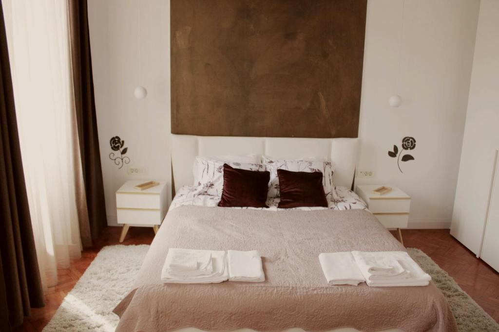 a bedroom with a large bed with two towels on it at Apartment Amber Rijeka in Rijeka