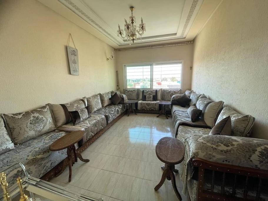un grand salon avec des canapés et un lustre dans l'établissement Calm apartment with a comfy queen bed in Fez 4th floor, à Fès