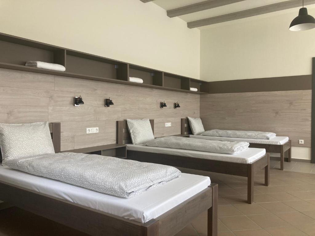 A bed or beds in a room at Szürke Juhar Vendégház
