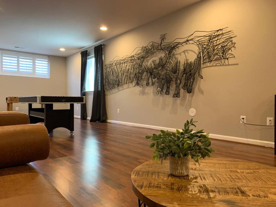 a living room with a table and a piano at LUX HOME 5 BD, GIFT CARD, GAME ROOM, and more! in Ashburn