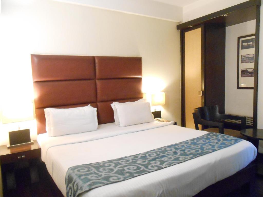Postel nebo postele na pokoji v ubytování Hotel Metropole