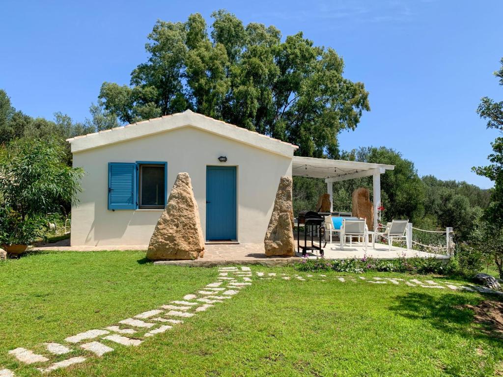 a small white house with a grass yard at La Casa di Alice Turchese in Olbia