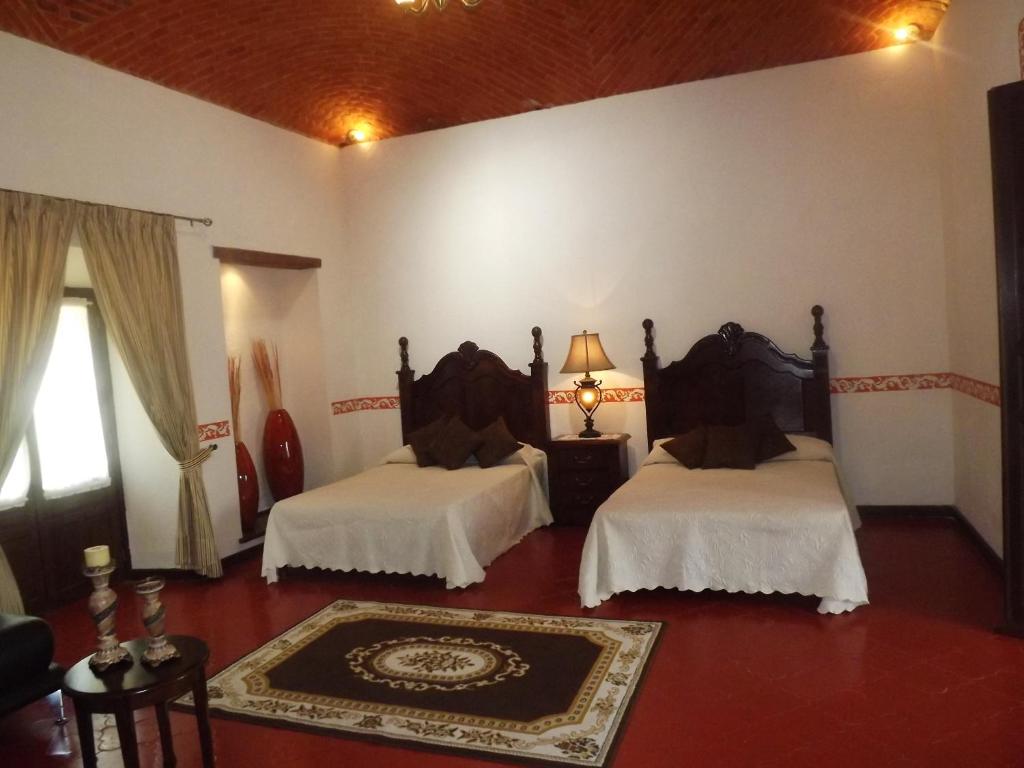 Postel nebo postele na pokoji v ubytování Hotel Spa Hacienda Real la Nogalera