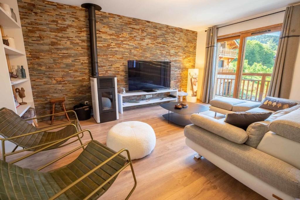a living room with a brick wall at Chalet Gaïla in Méribel