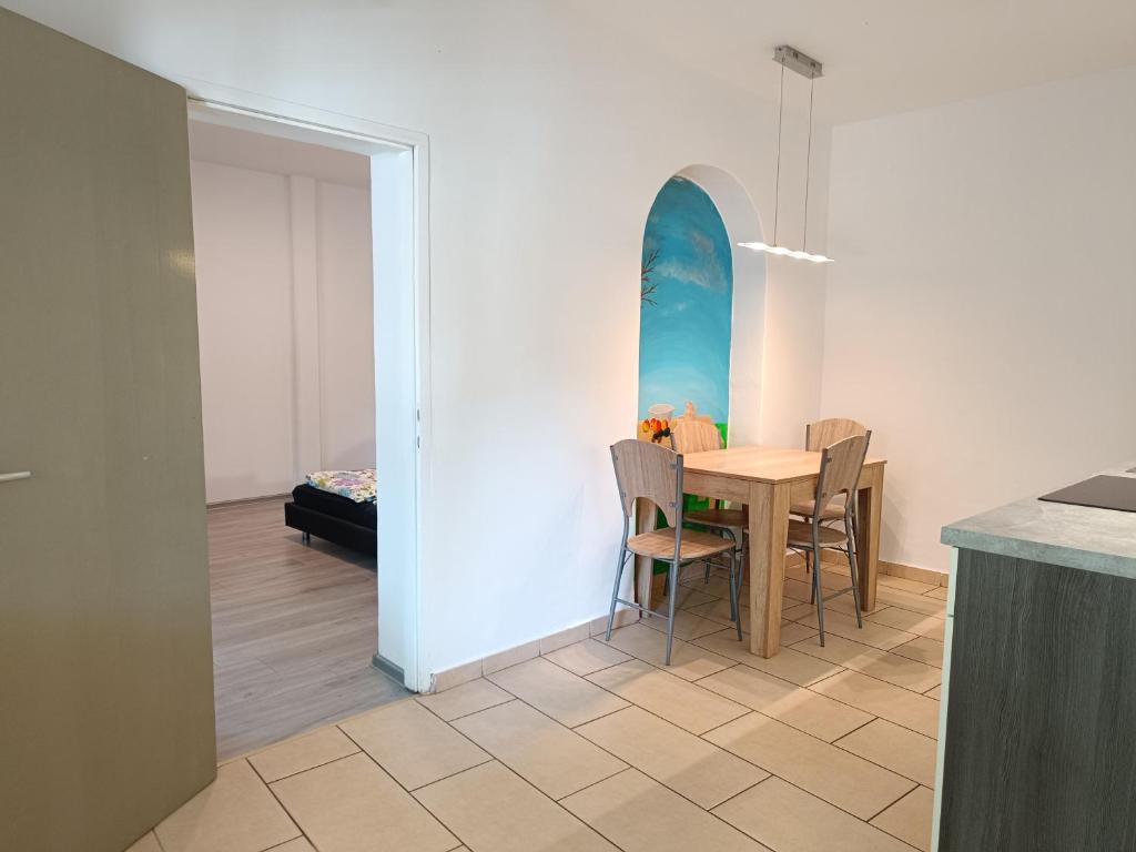 a dining room with a table and a surfboard on the wall at Apartments Abc Ljubljana in Ljubljana