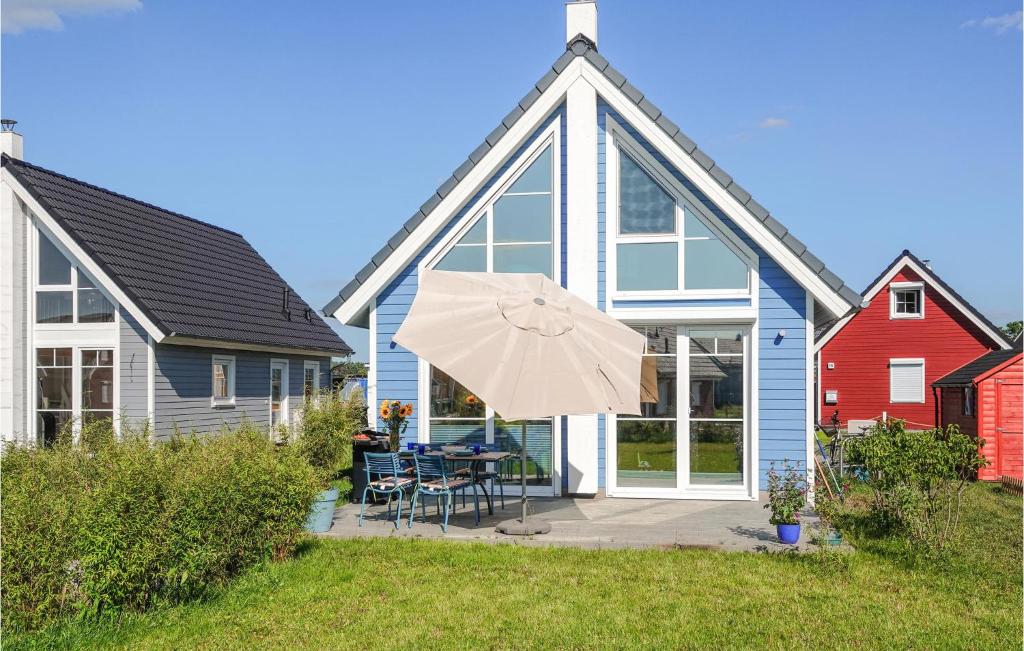 a house with a patio with a table and an umbrella at Lovely Home In Zerpenschleuse With Wifi in Berg