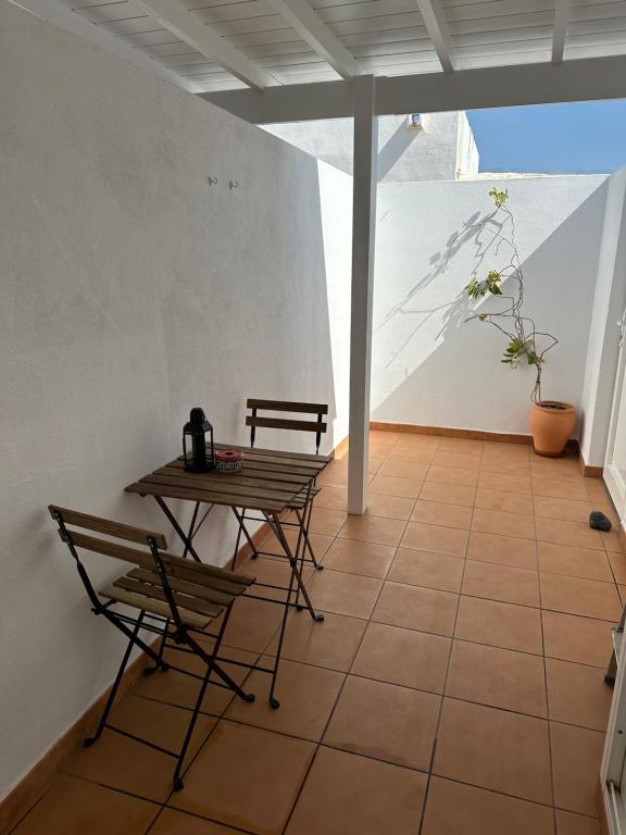 a room with a table and chairs on a tiled floor at Apartamento Emma in Puerto del Carmen