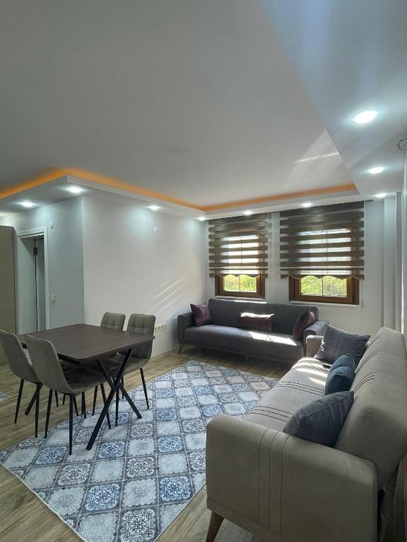 a living room with a couch and a table at Kaya Palace in Uzungöl