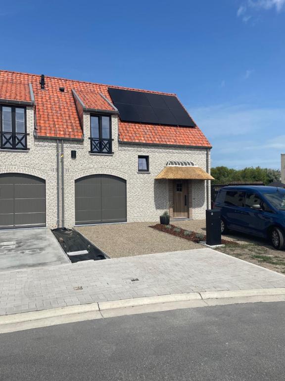 a house with solar panels on top of it at Noordzeehuys in Middelkerke