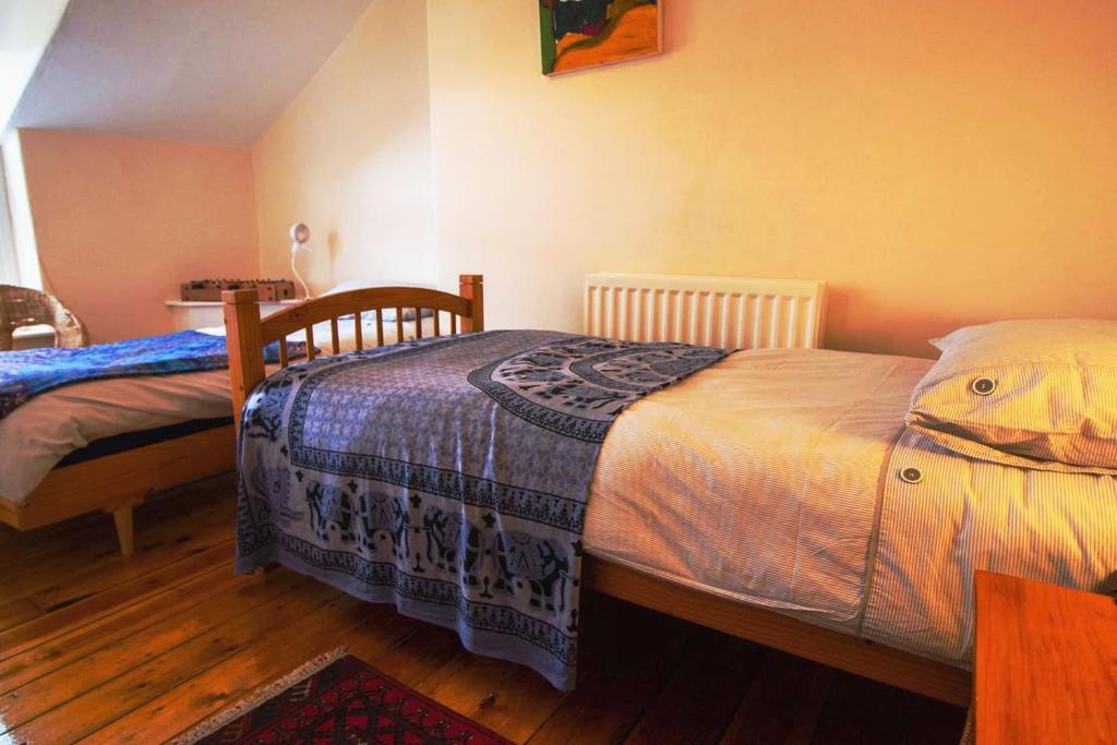 a bedroom with two twin beds and a wooden floor at SPACIOUS HOUSE in Morecambe