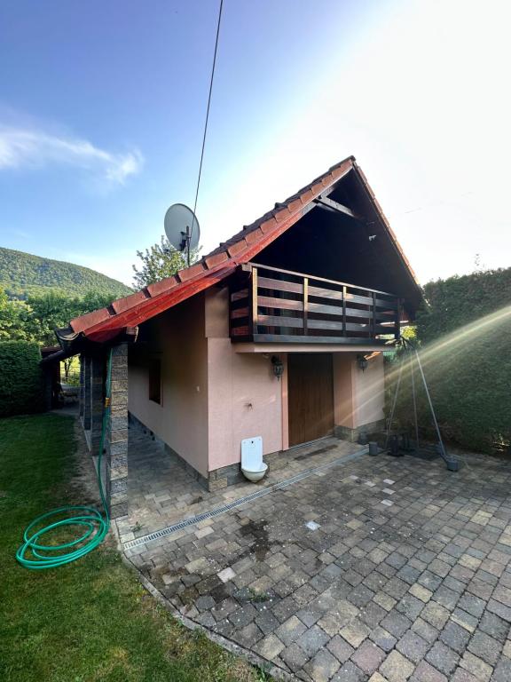 a small house with a balcony at Village Light House in Omšenie