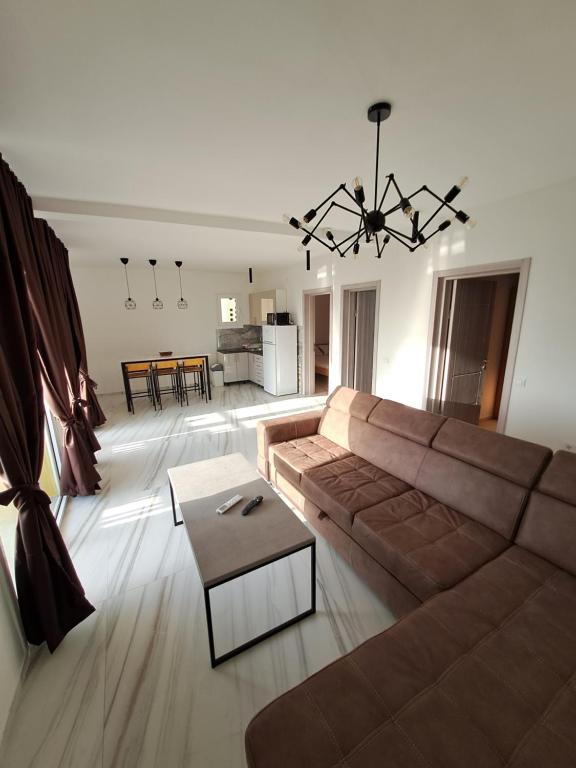 a living room with a couch and a table at Apartments MileS in Utjeha