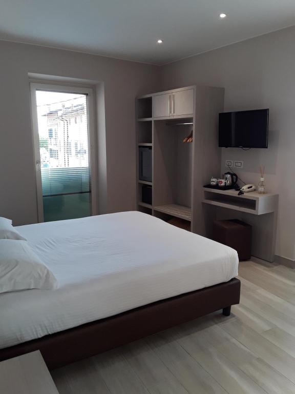 Postel nebo postele na pokoji v ubytování Hotel Danieli La Castellana lago di Garda