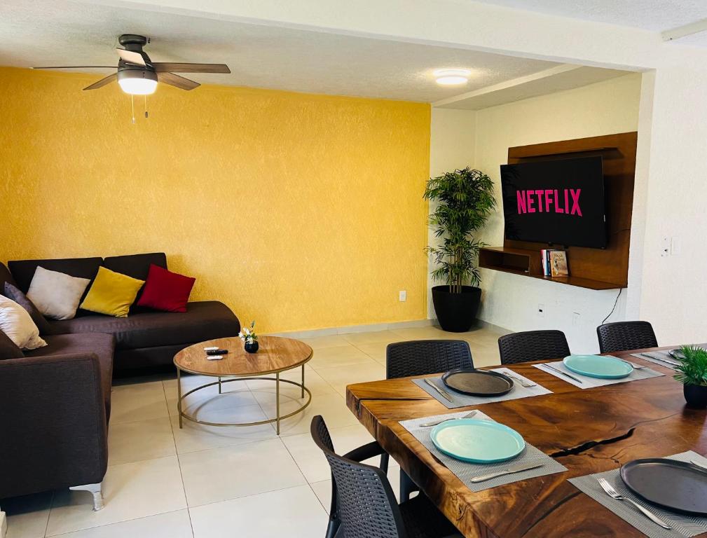 sala de estar con sofá y mesa en Casa Recién Remodelada Con Alberca a8 min de playa en Ixtapa