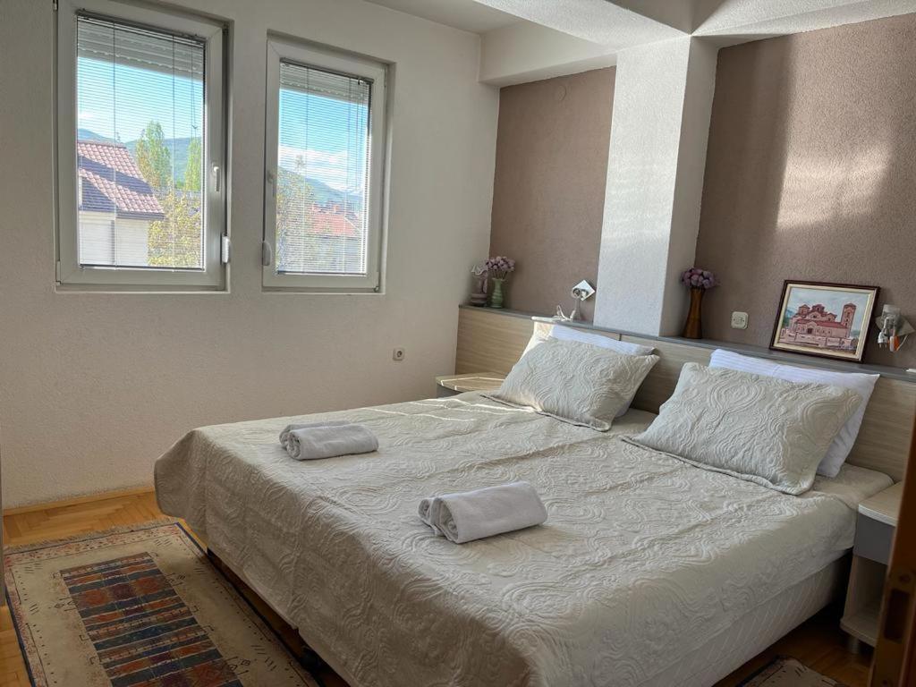 a bedroom with a large bed with two pillows on it at Volkan Apartments in Ohrid