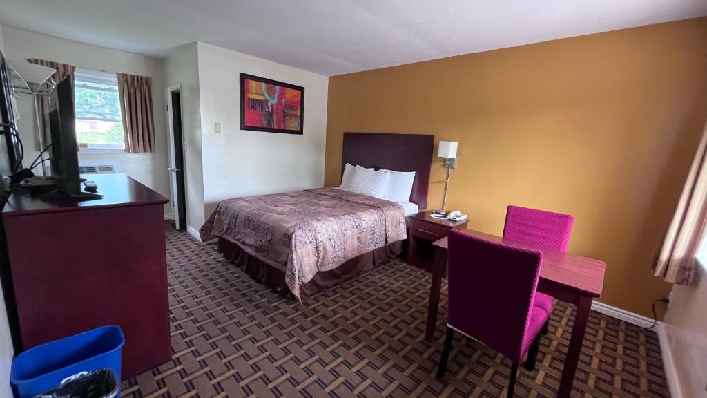 Postel nebo postele na pokoji v ubytování Park Place Motel & Suites