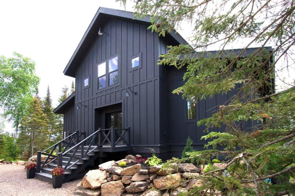 a black house with a black roof at NEW Rustic Modern Cabin at Lutsen Mountains in Lutsen