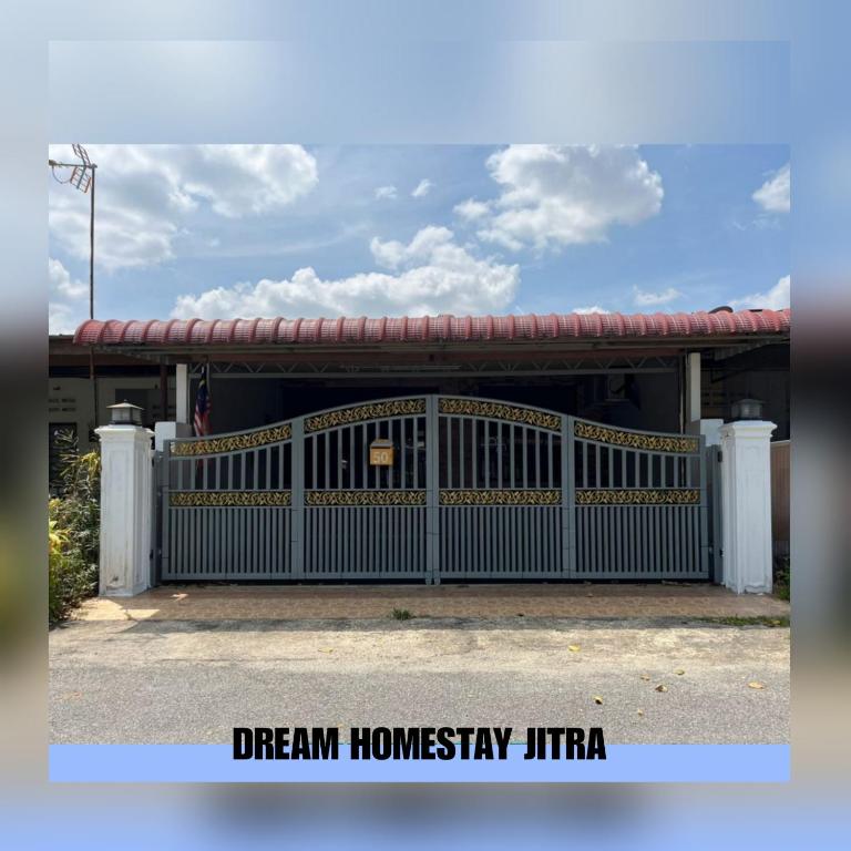 a house with a gate in front of it at Homestay Jitra Dream Homestay in Jitra