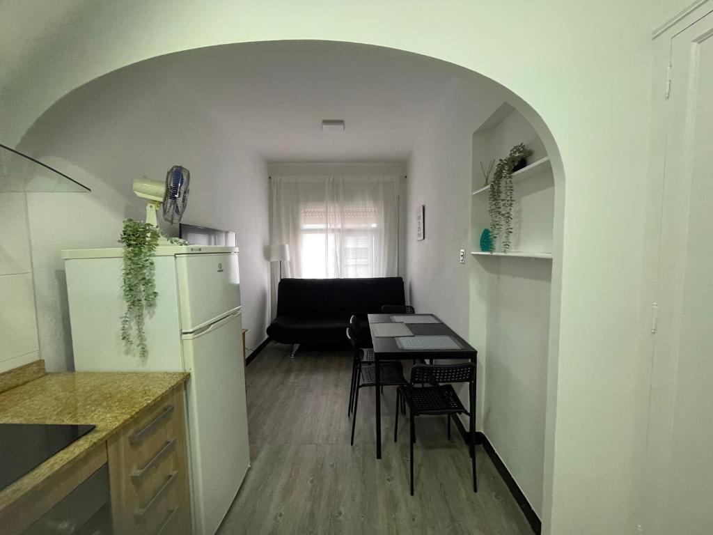 cocina y comedor con mesa y nevera en Apartamento Forn Vell en Sant Feliu de Guixols