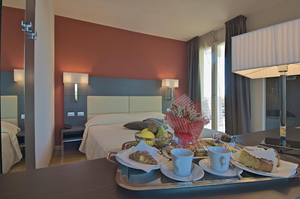 a hotel room with a tray of food on a table at Zen Hotel Versilia in Marina di Pietrasanta
