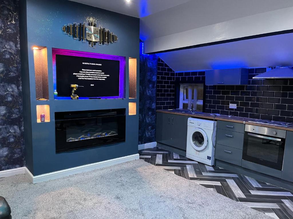 a kitchen with a fireplace and a washer and dryer at Private Penthouse Suite 
