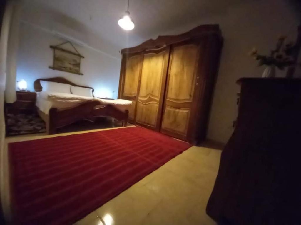 a living room with a bed and a red rug at Makramia holiday rental in Hurghada