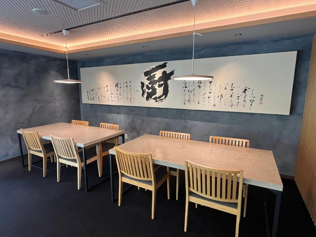 a dining room with two tables and chairs at Kuriya Suizan in Jozankei