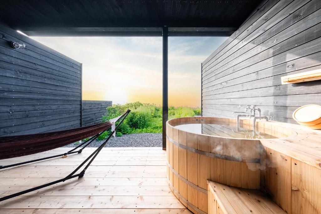 a large bathroom with a tub and a hammock at The OCEAN VISTA in Shiraoi