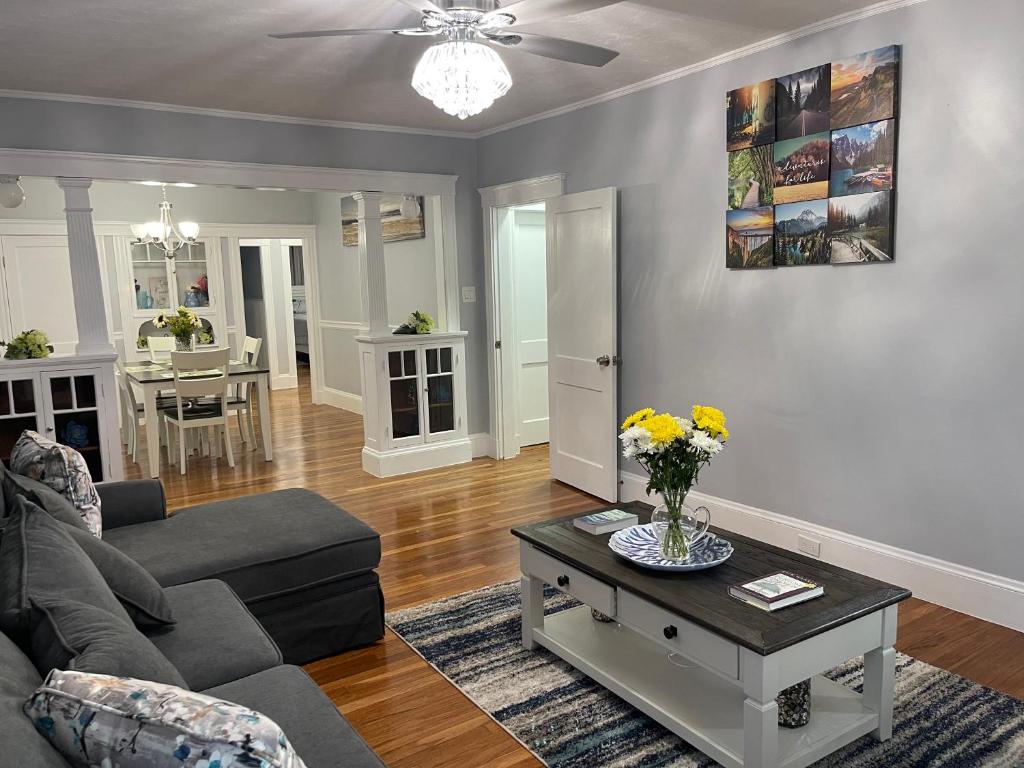 a living room with a couch and a table at Boston Luxury Condo Style Rooms in Boston