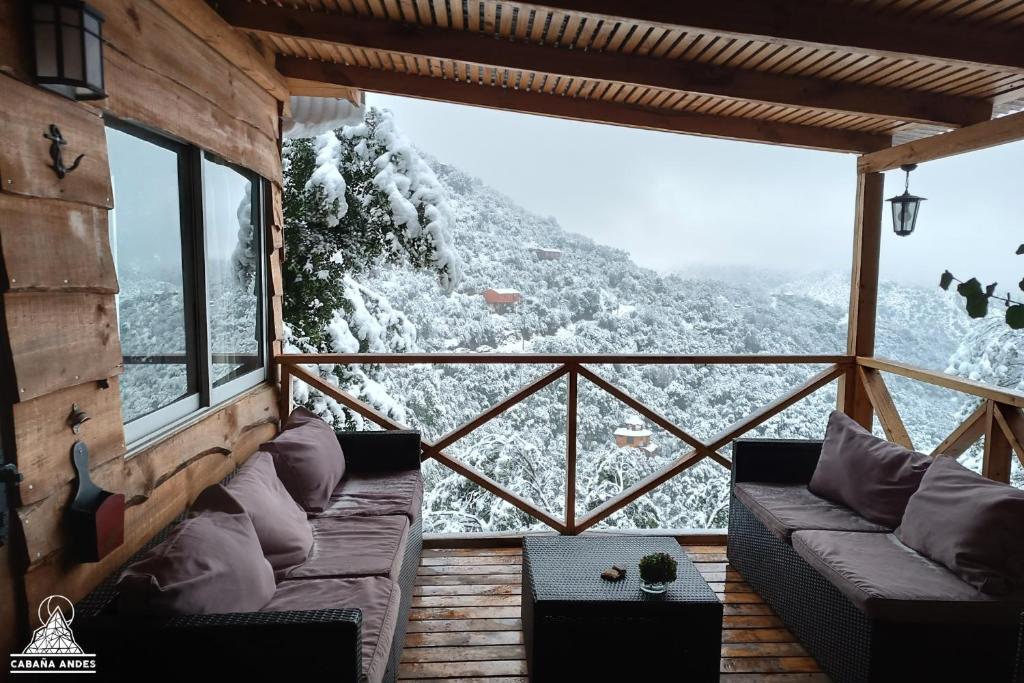 a room with a view of a snowy mountain at Cabaña Andes in El Canelo