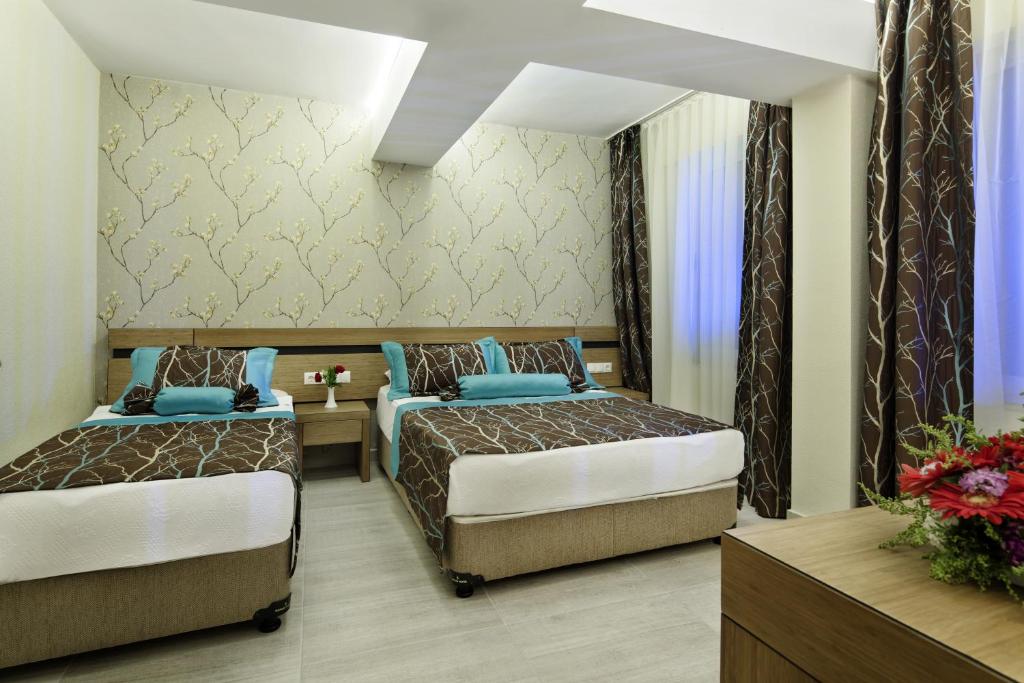 Postel nebo postele na pokoji v ubytování Saphir Hotel & Villas
