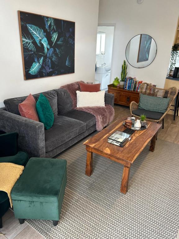 a living room with a couch and a coffee table at Sunshine Four in Salisbury